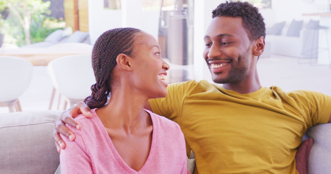 Smiling African American Couple Relaxing on Sofa at Home