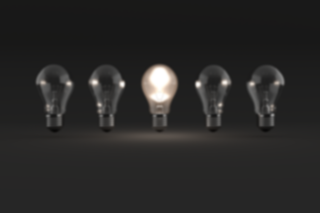 Transparent light bulbs with one glowing on dark background - Download Free Stock Images Pikwizard.com