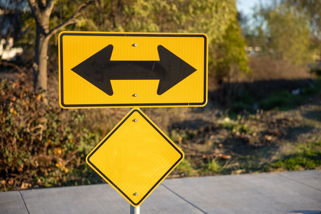 Yellow Crossroad Debugging Directional Sign with Arrows