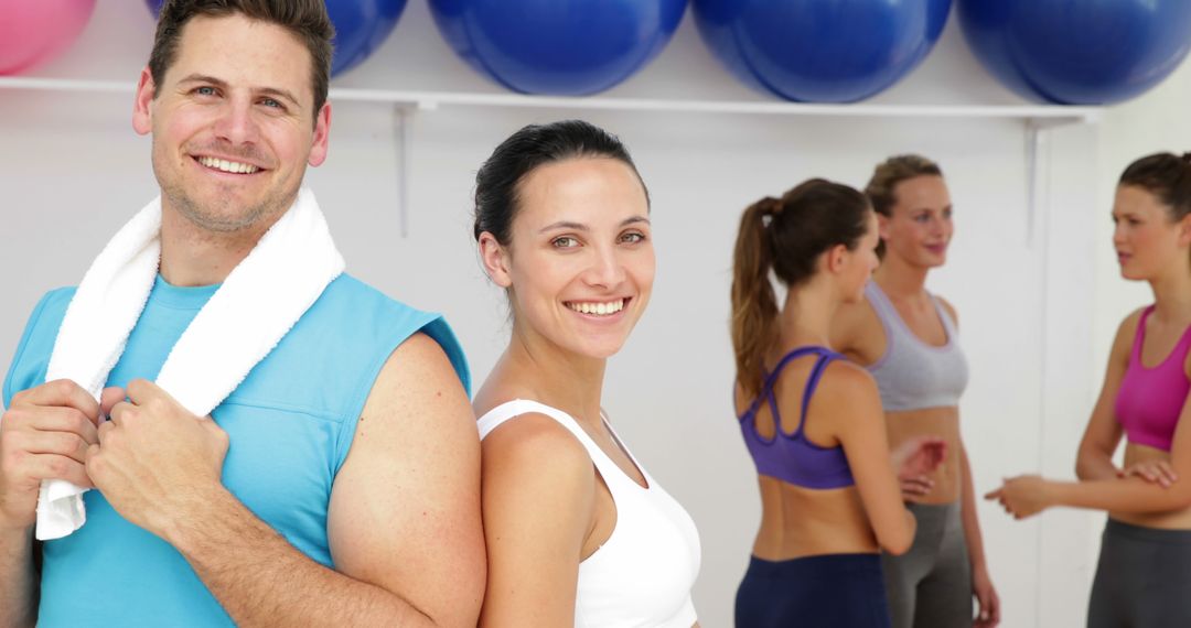 Smiling fitness instructors with gym members in fitness center - Free Images, Stock Photos and Pictures on Pikwizard.com