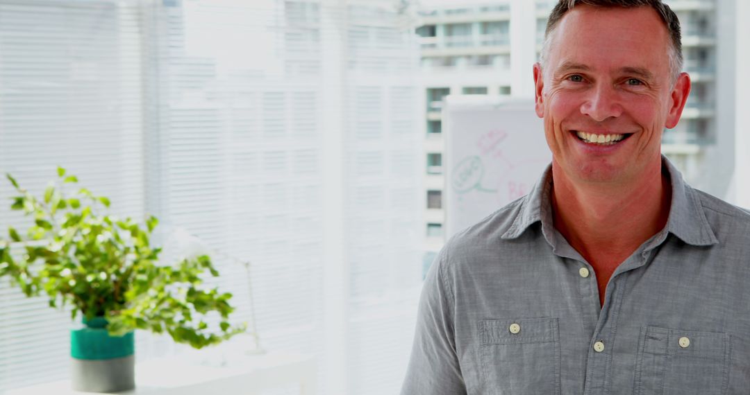 Confident Male Executive Smiling in Modern Office Environment
