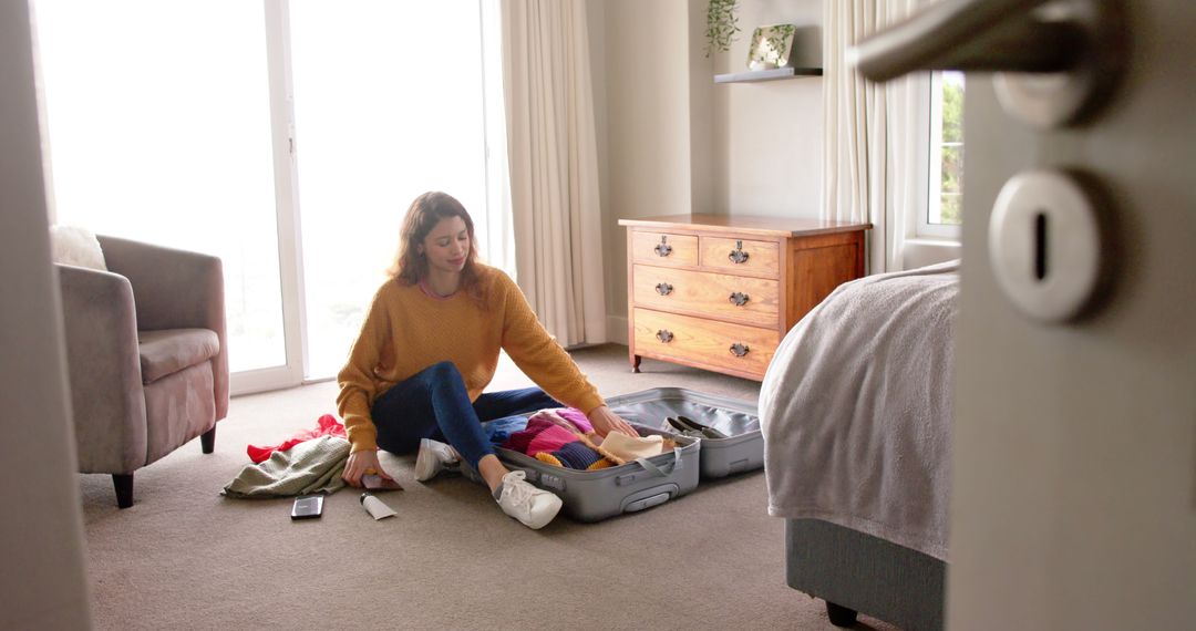 Woman Packing Suitcase in Modern Hotel Room for Travel - Free Images, Stock Photos and Pictures on Pikwizard.com