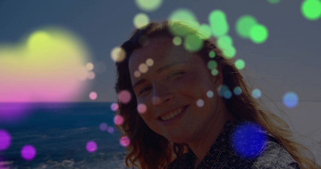 Smiling Woman by Ocean with Colorful Bokeh Overlay