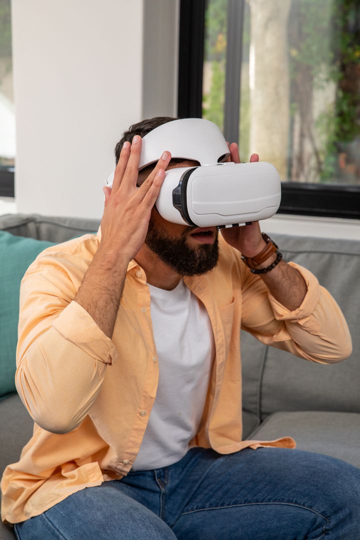 Man with VR Headset Enjoying Virtual Reality at Home