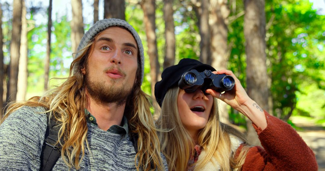 Excited Couple Birdwatching in Forest with Binoculars - Free Images, Stock Photos and Pictures on Pikwizard.com