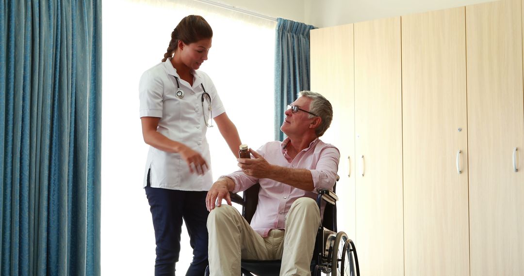 Nurse assisting elderly man in wheelchair in medical facility - Free Images, Stock Photos and Pictures on Pikwizard.com