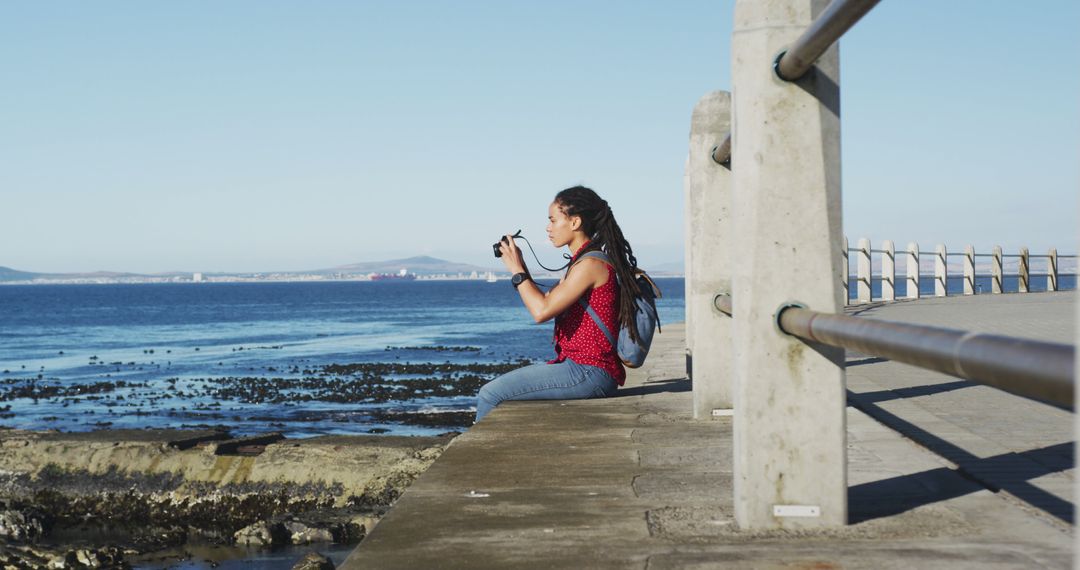 Woman Photographing Sea Scenery on Seaside Promenade - Free Images, Stock Photos and Pictures on Pikwizard.com