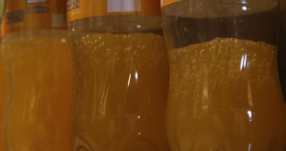 Close-Up of Orange Juice Bottles with Bubbles - Free Images, Stock Photos and Pictures on Pikwizard.com