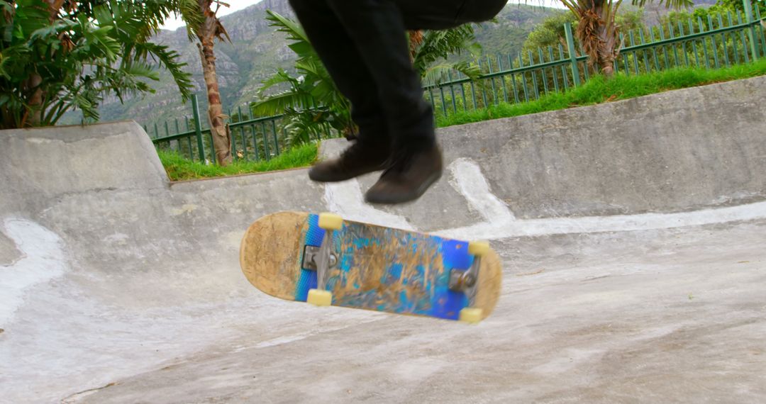 Skateboarder Performing Mid-Air Flip Trick in Skatepark - Free Images, Stock Photos and Pictures on Pikwizard.com