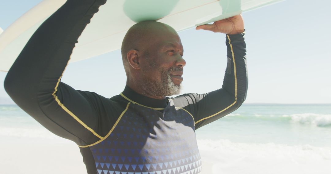 Senior Man Holding Surfboard on Sunny Day at Beach - Free Images, Stock Photos and Pictures on Pikwizard.com