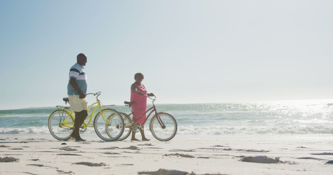 Senior African American Couple Enjoying Leisurely Bike Ride on Beach - Free Images, Stock Photos and Pictures on Pikwizard.com