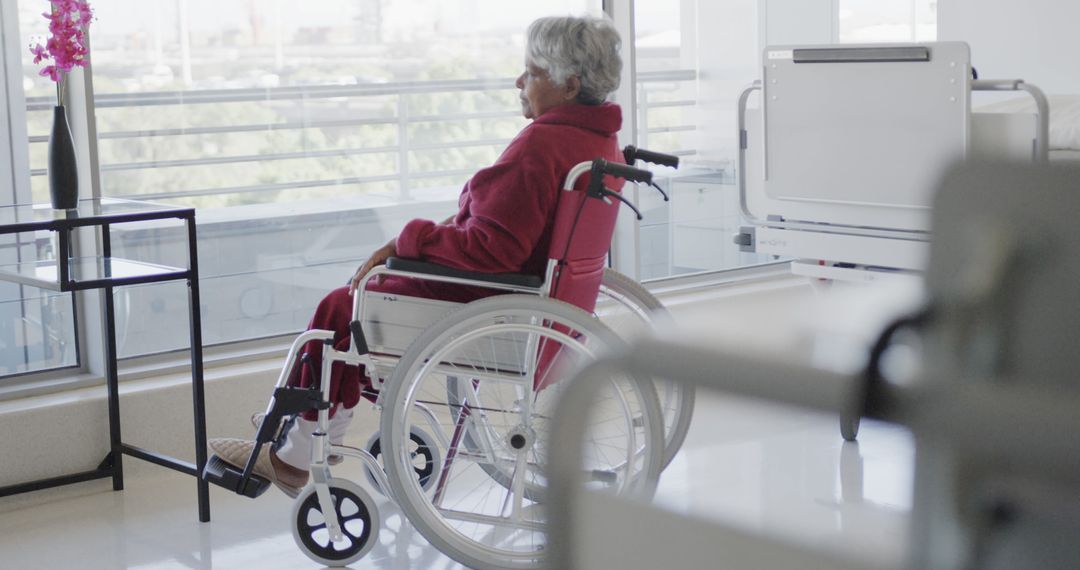 Senior Woman in Wheelchair Looking out Hospital Window - Free Images, Stock Photos and Pictures on Pikwizard.com