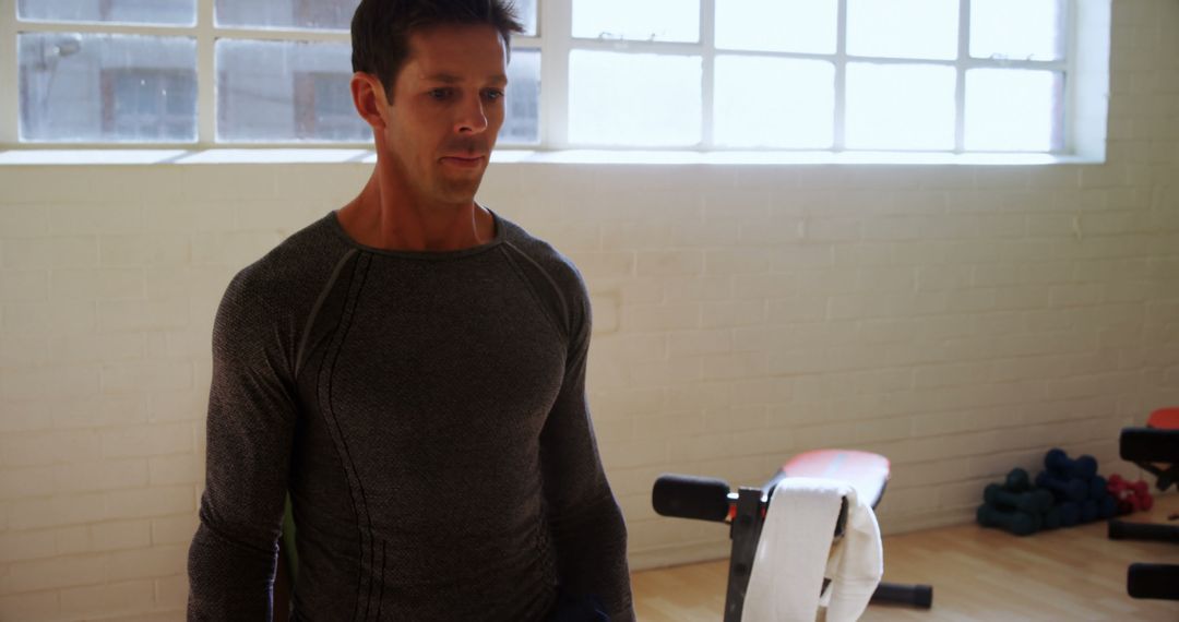 Man Working Out in Gym Wearing Long Sleeve Athletic Shirt - Free Images, Stock Photos and Pictures on Pikwizard.com