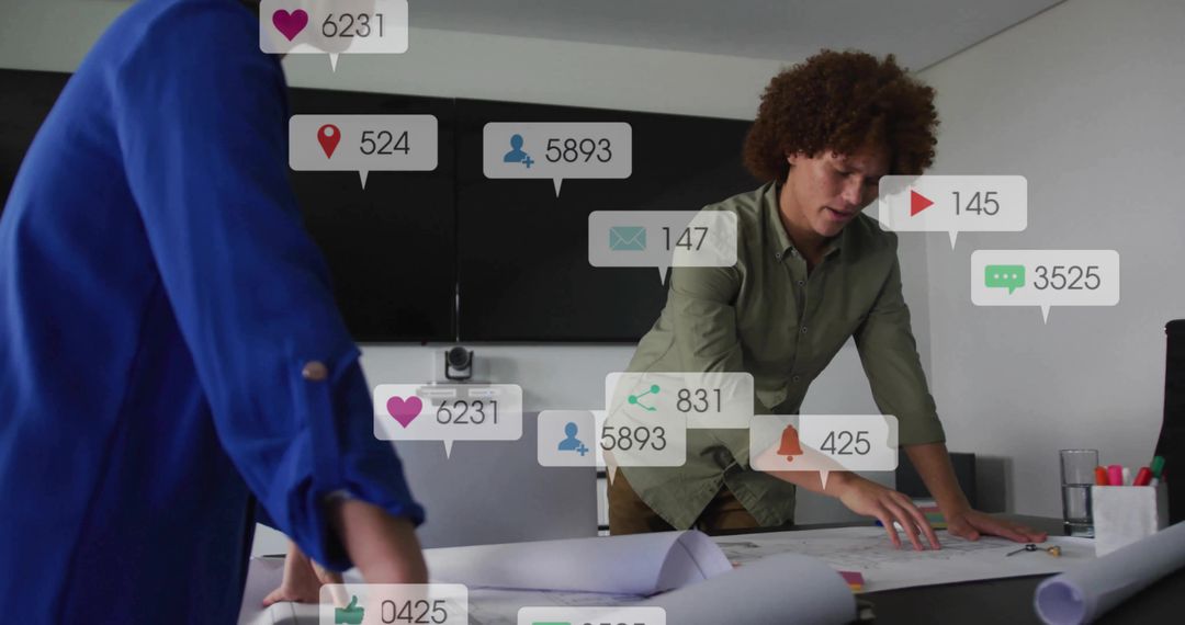 Leaning Team Collaborating Over Blueprints While Tracking Social Media Metrics