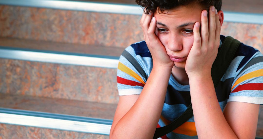 Solemn Teenager Contemplating on Staircase