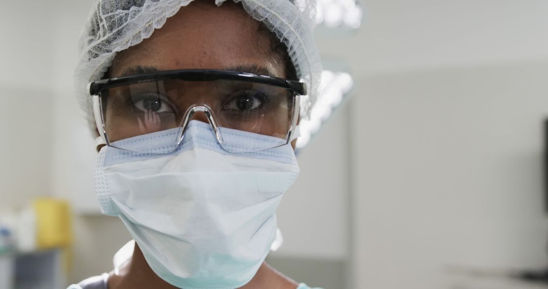 Healthcare Worker in Protective Gear Focused on Patient Care - Free Images, Stock Photos and Pictures on Pikwizard.com