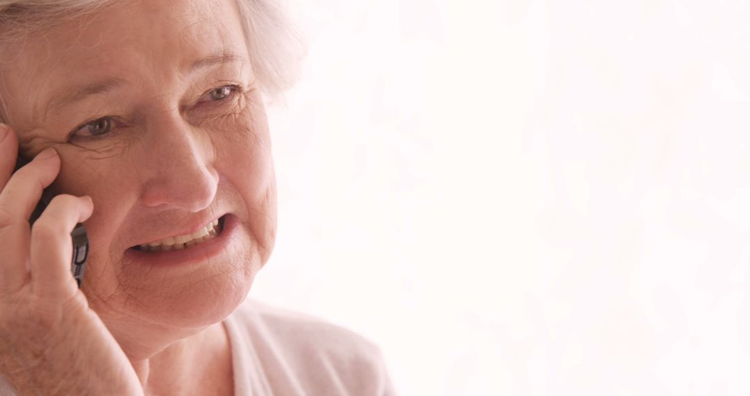 Elderly Woman Expressing Concern While Talking on Phone - Free Images, Stock Photos and Pictures on Pikwizard.com