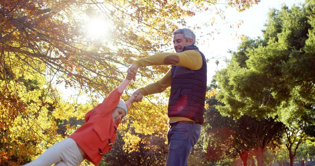 Father Playing with Daughter in Autumn Park - Free Images, Stock Photos and Pictures on Pikwizard.com