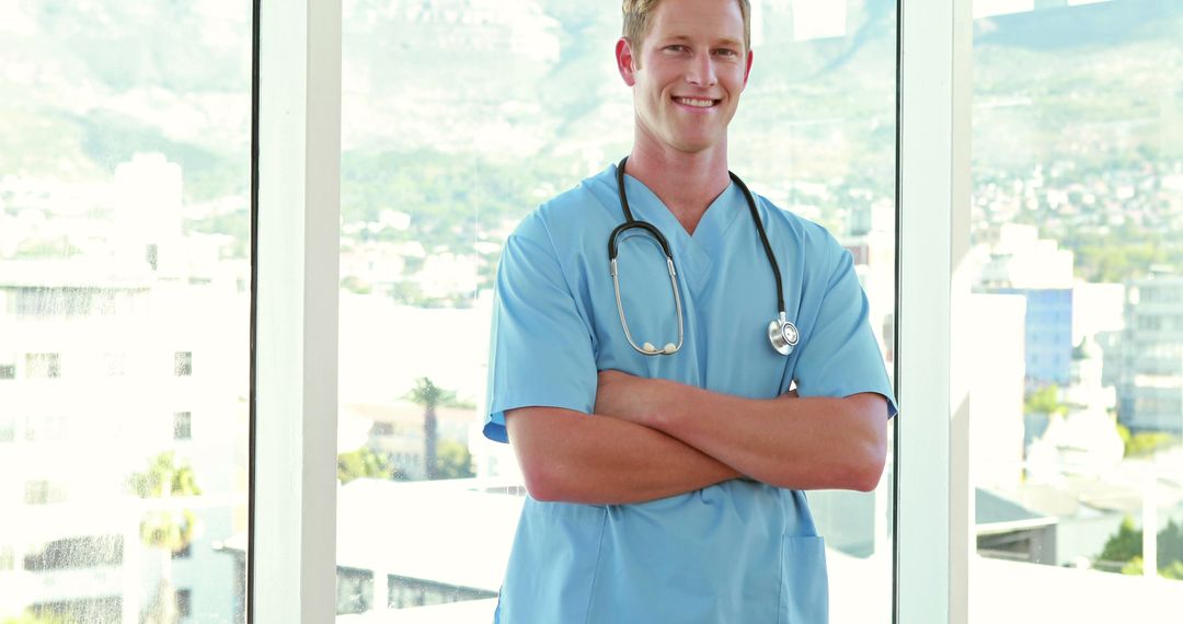 Confident Male Doctor Standing with Arms Crossed in Hospital - Free Images, Stock Photos and Pictures on Pikwizard.com