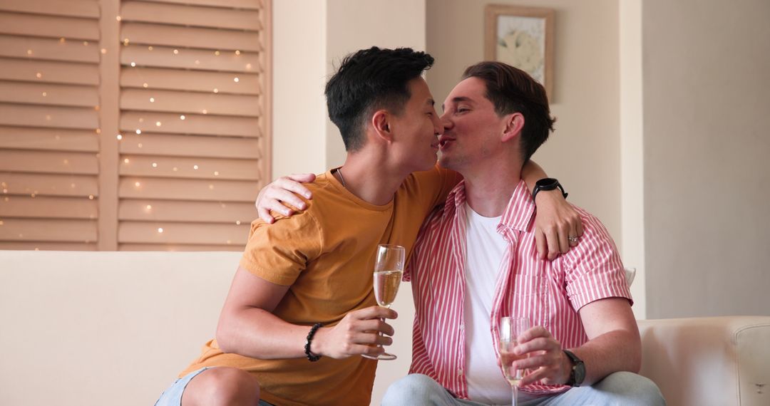 Diverse Male Couple Enjoying Drinks Together at Home
