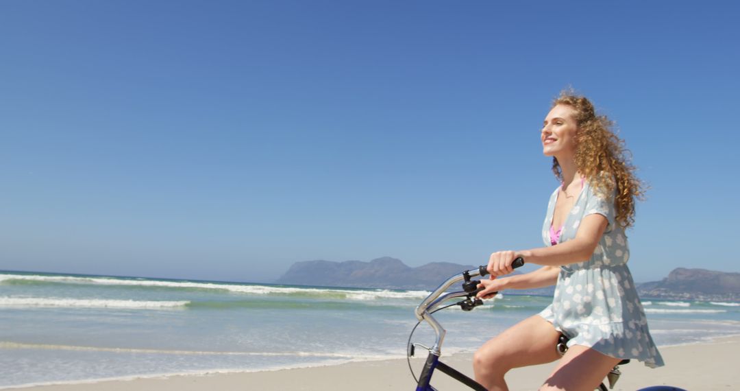 Young Woman Riding Bicycle on Sunny Beach Day - Free Images, Stock Photos and Pictures on Pikwizard.com