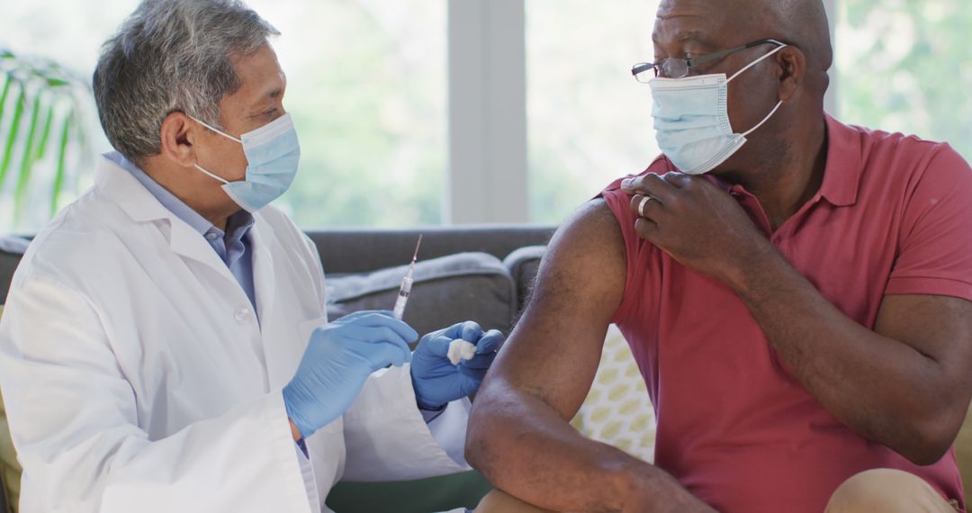 Doctor Administering Vaccine Shot to Senior Male Patient at Clinic - Free Images, Stock Photos and Pictures on Pikwizard.com