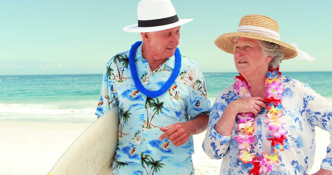 Elderly couple wearing leis enjoying beach vacation - Free Images, Stock Photos and Pictures on Pikwizard.com