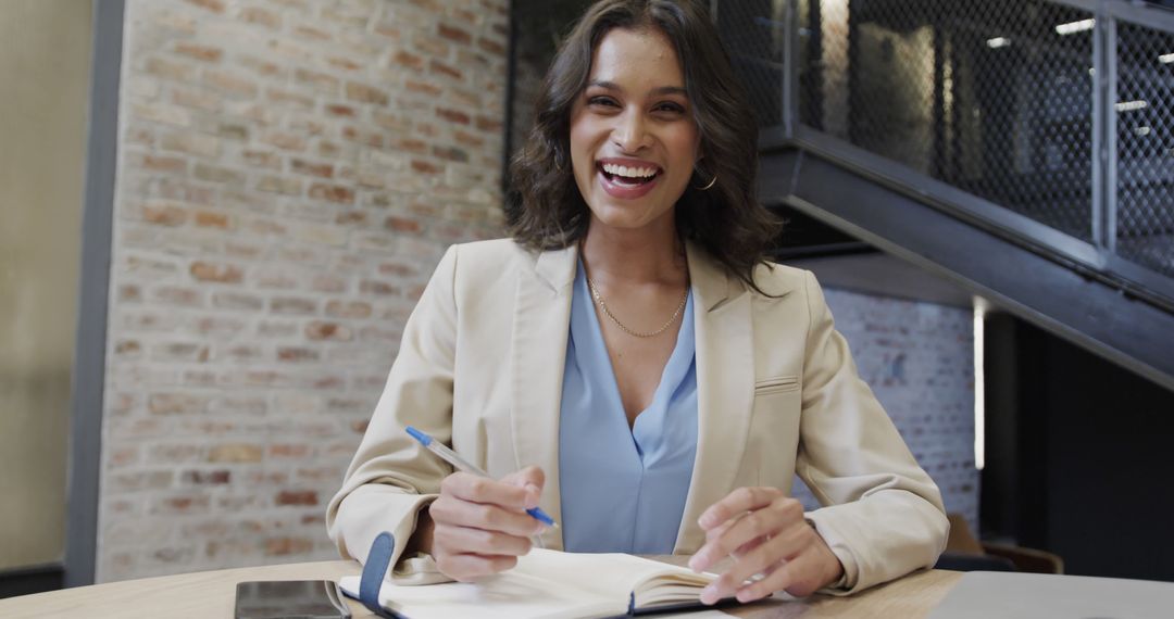 Smiling Businesswoman Taking Notes During Meeting - Free Images, Stock Photos and Pictures on Pikwizard.com