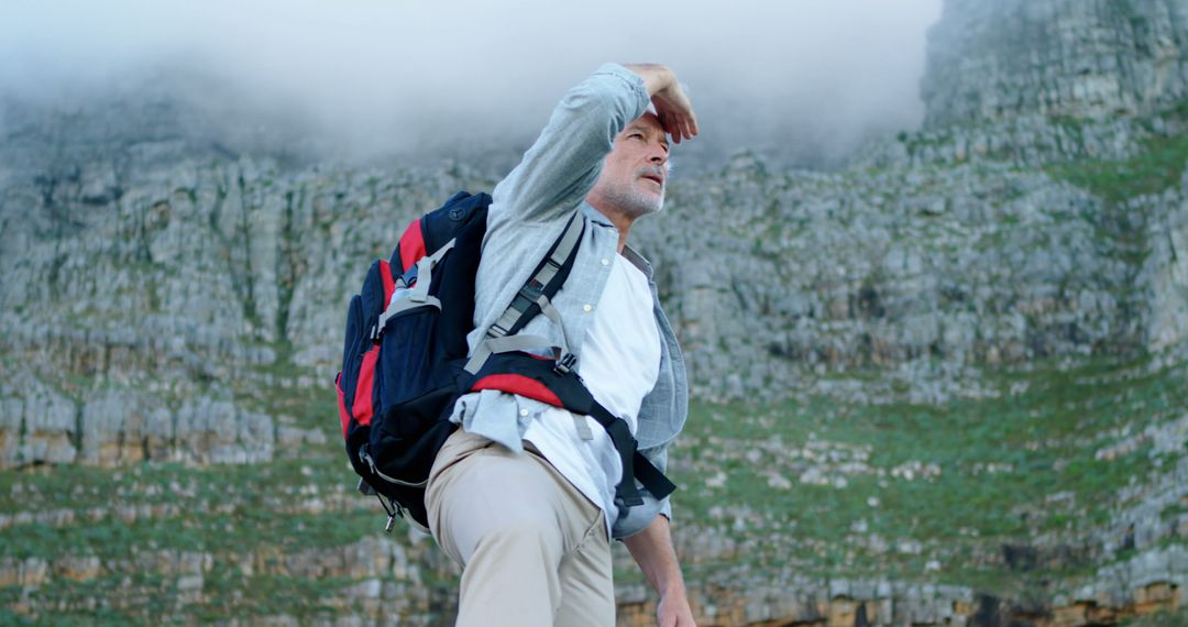 Senior Man Hiking with Backpack in Mountain Scenery - Free Images, Stock Photos and Pictures on Pikwizard.com