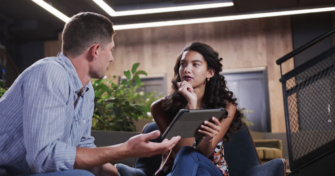 Diverse Office Team Discussing Ideas in Relaxed Workspace