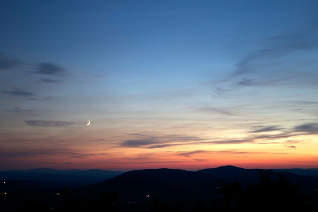 Peaceful Twilight with Crescent Moon over Serene Hills - Free Images, Stock Photos and Pictures on Pikwizard.com