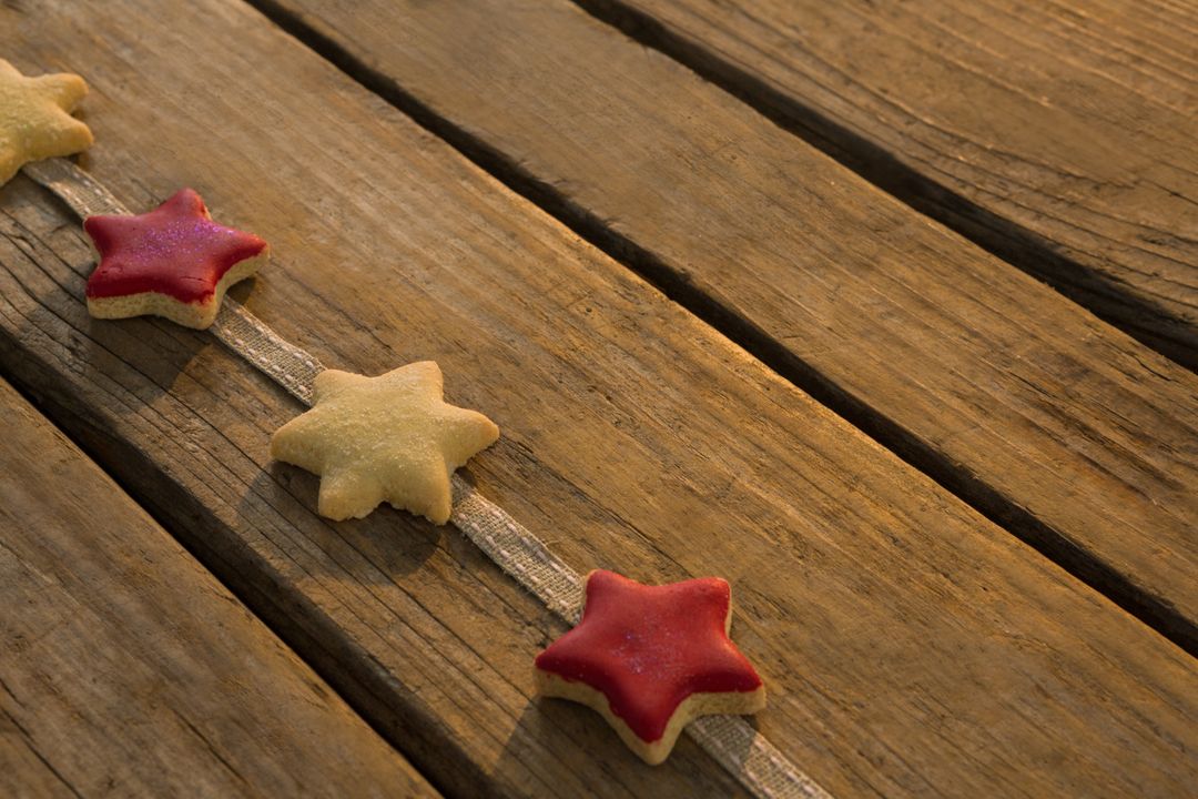 High angle view of star shaped cookies arranged on ribbon at table - Free Images, Stock Photos and Pictures on Pikwizard.com