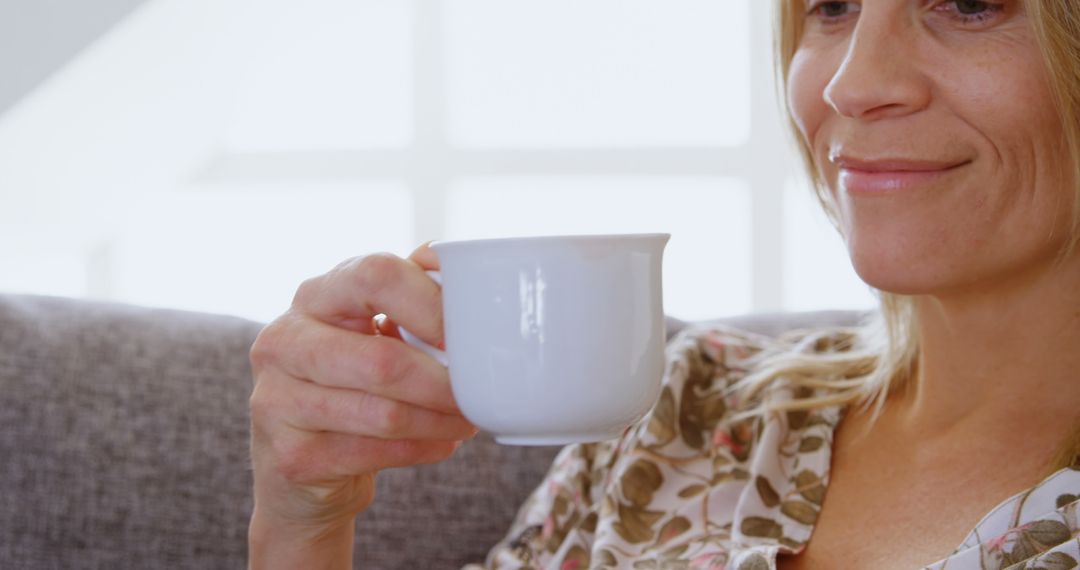 Smiling Woman Enjoying Morning Tea in Cozy Home Setting - Free Images, Stock Photos and Pictures on Pikwizard.com