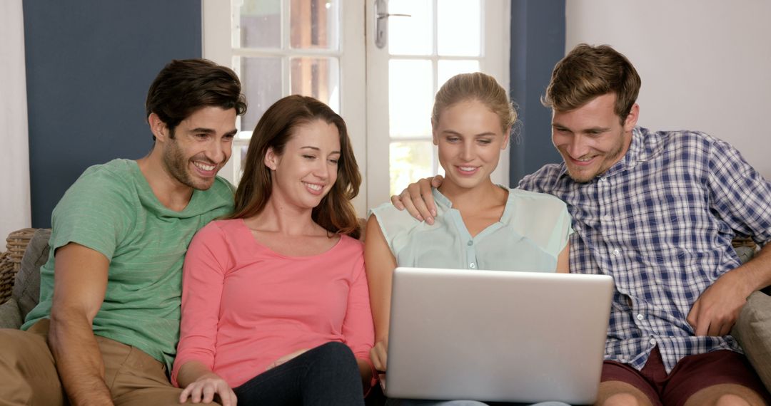 Friends Sitting on Sofa Using Laptop at Home - Free Images, Stock Photos and Pictures on Pikwizard.com