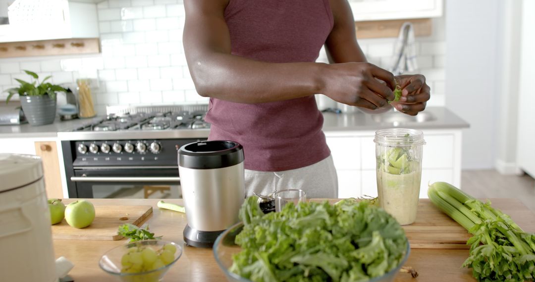 Man Preparing Fresh Smoothie in Modern Kitchen - Free Images, Stock Photos and Pictures on Pikwizard.com