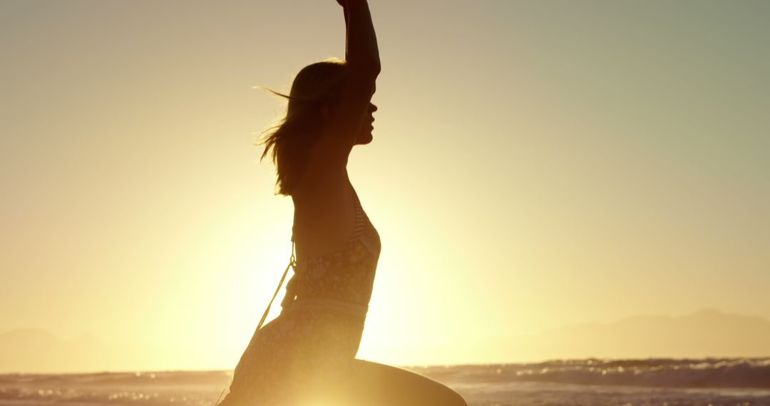 Silhouette of Woman Practicing Yoga on Beach at Sunrise - Free Images, Stock Photos and Pictures on Pikwizard.com