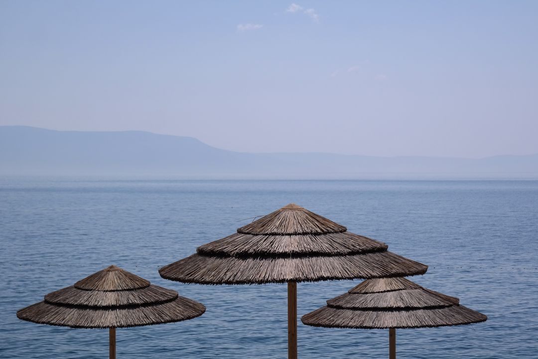 Tranquil Mediterranean Beach with Wicker Umbrellas