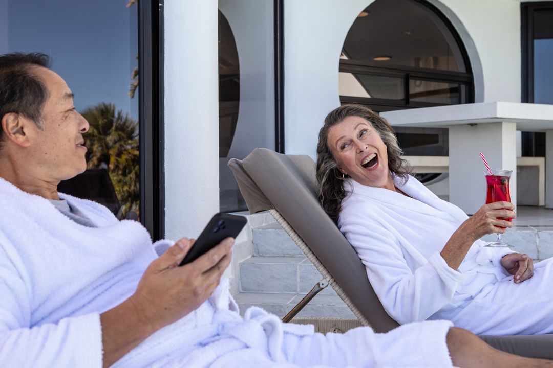 Senior Couple Enjoying Relaxation on Spa Terrace with Drinks
