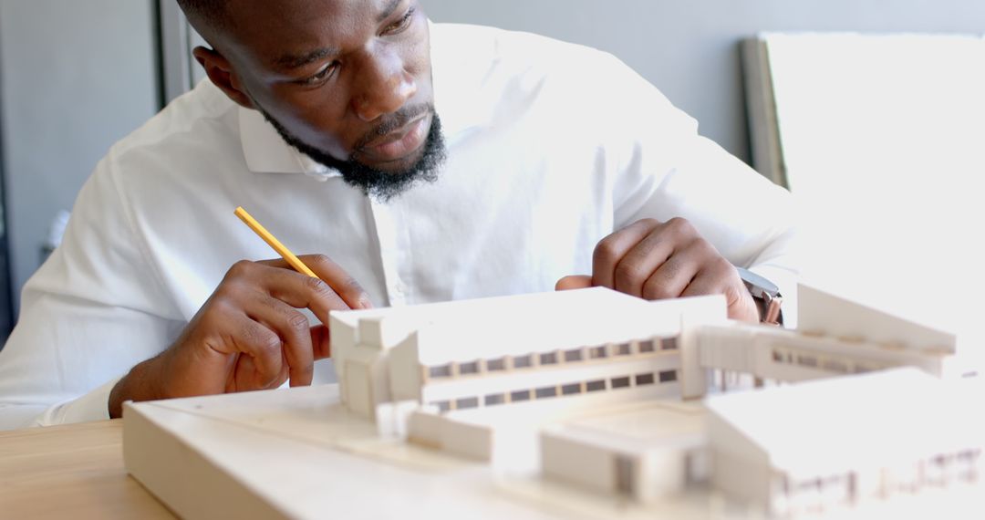 Architect Adjusting Building Model with Precision and Focus