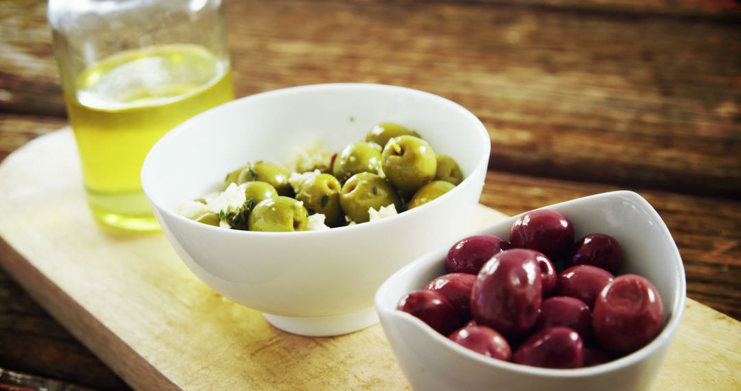 Green and Black Olives in White Bowls on Wooden Board - Free Images, Stock Photos and Pictures on Pikwizard.com