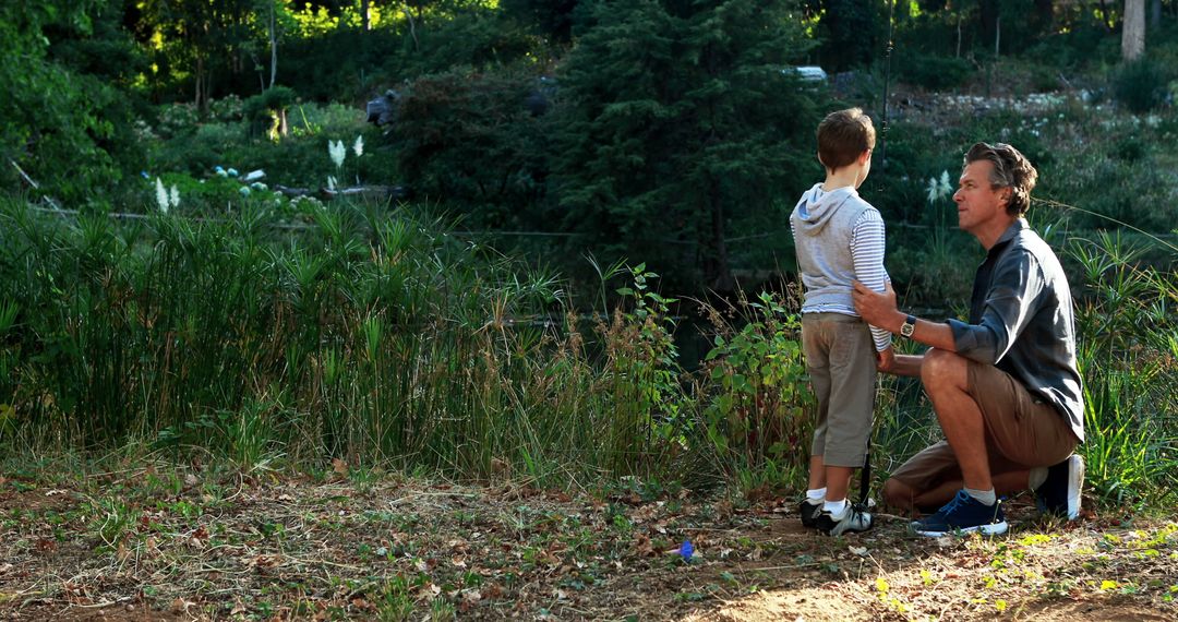 Father and Son Sharing Moment in Peaceful Park Scene - Free Images, Stock Photos and Pictures on Pikwizard.com