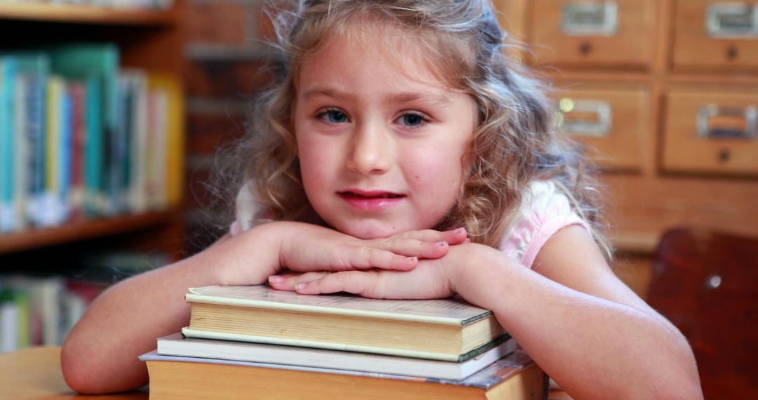 Curly Haired Young Girl with Books in a Library - Free Images, Stock Photos and Pictures on Pikwizard.com