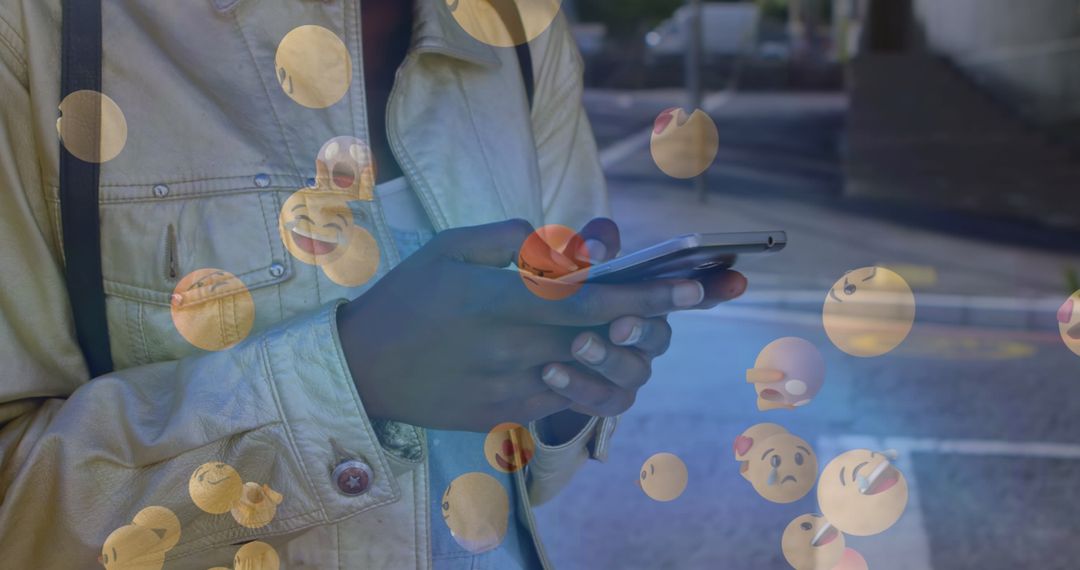 Smiling Emojis with Person Using Smartphone Outdoors
