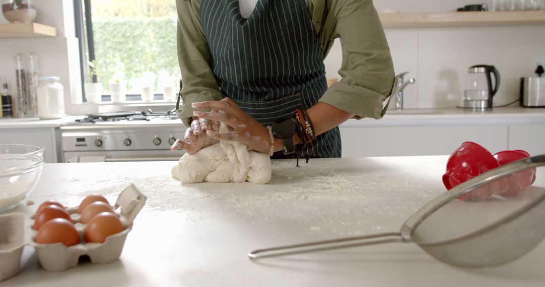 Confident Young Chef Kneading Dough in Modern Kitchen