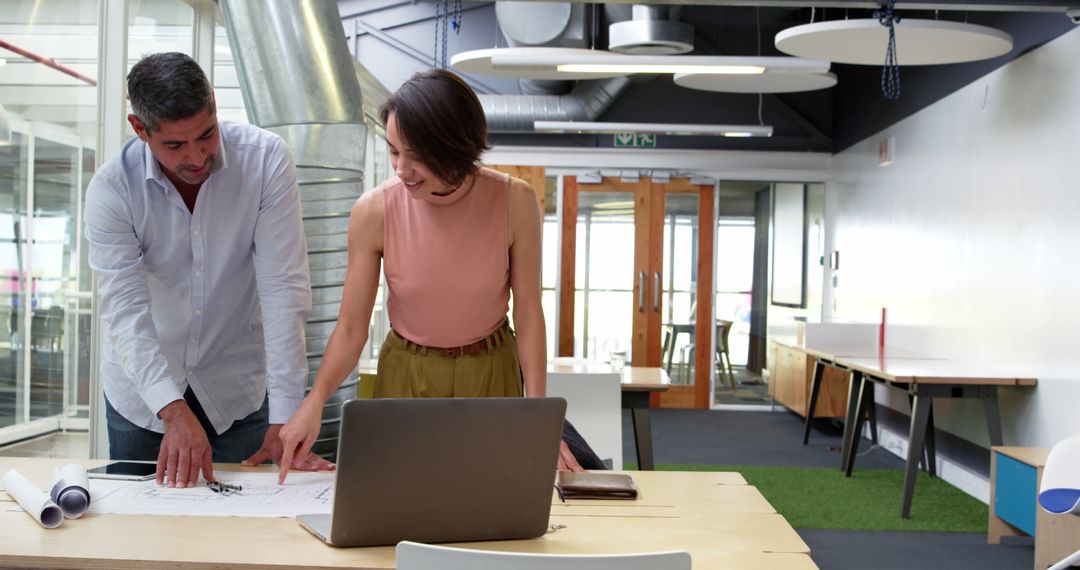 Collaboration Over Blueprint in Modern Office Space