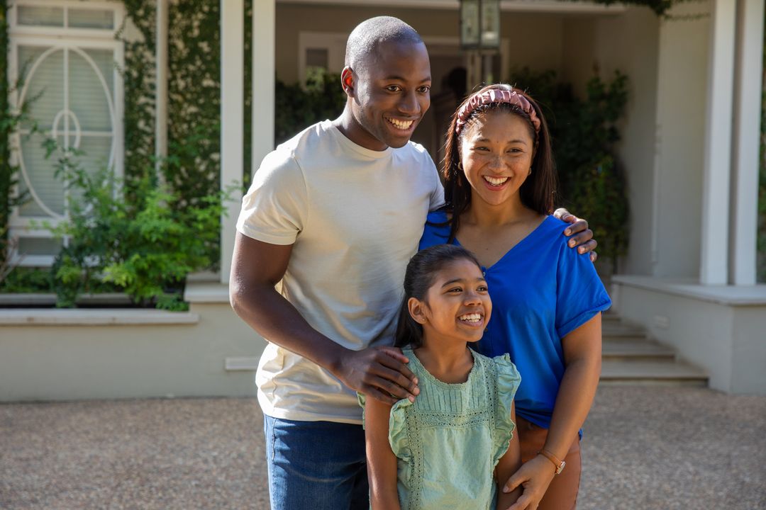 Smiling Family Posing Together on Sunny Veranda