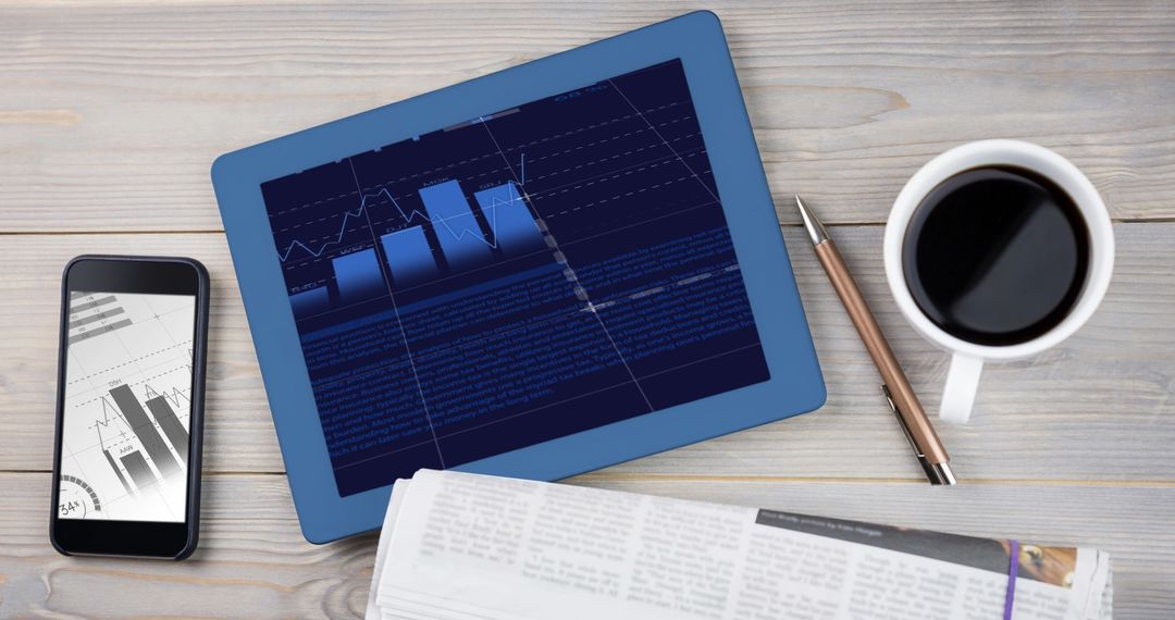 Digital Financial Analysis with Tablet and Smartphone on Wooden Desk