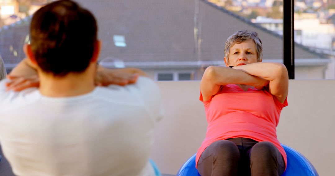 Senior Woman Exercising with Physioball in Fitness Class - Free Images, Stock Photos and Pictures on Pikwizard.com