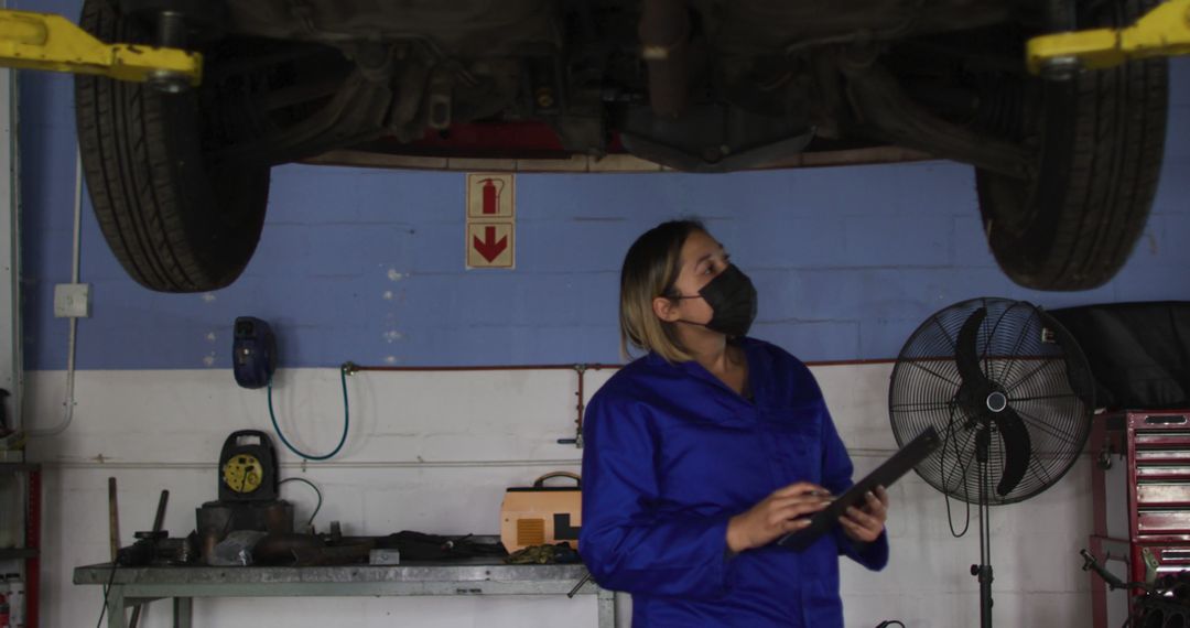 Female Mechanic Inspecting Vehicle in Auto Repair Shop - Free Images, Stock Photos and Pictures on Pikwizard.com