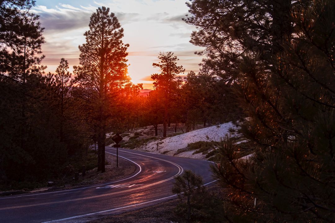 Serene Mountain Road at Sunset with Radiant Sky - Free Images, Stock Photos and Pictures on Pikwizard.com